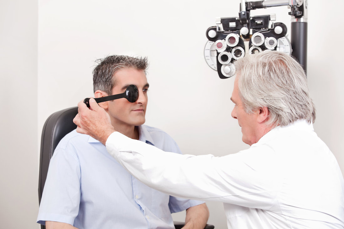 man is getting his eyes checked 